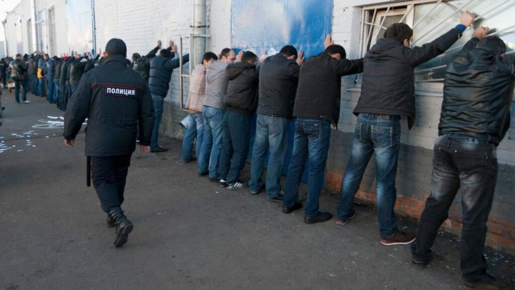 Russian police detain migrant workers during a raid at a vegetable warehouse complex in the Biryulyovo district of Moscow on Monday. Photograph: Ivan Stolpnikov/Reuters