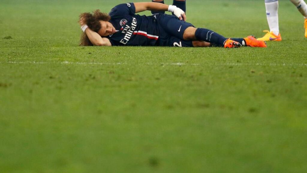 David Luiz lies prone on the ground during PSG’s 3-1 Champions League quater-final defeat to Barcelona. Photograph: Reuters