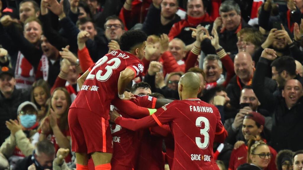 Liverpool players celebrate their first goal against Villarreal at Anfield. Photograph: EPA
