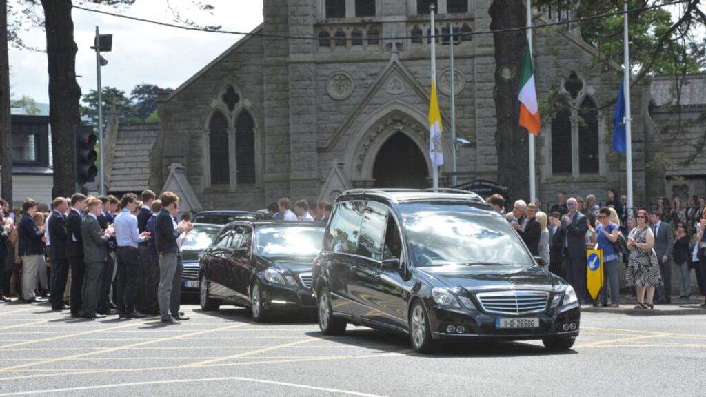 Family and friends applaud as the remains of Eoghan Culligan pass through a guard of honour after the funeral mass at the Church of the Annunciation in Rathfarnham. Photograph: Alan Betson