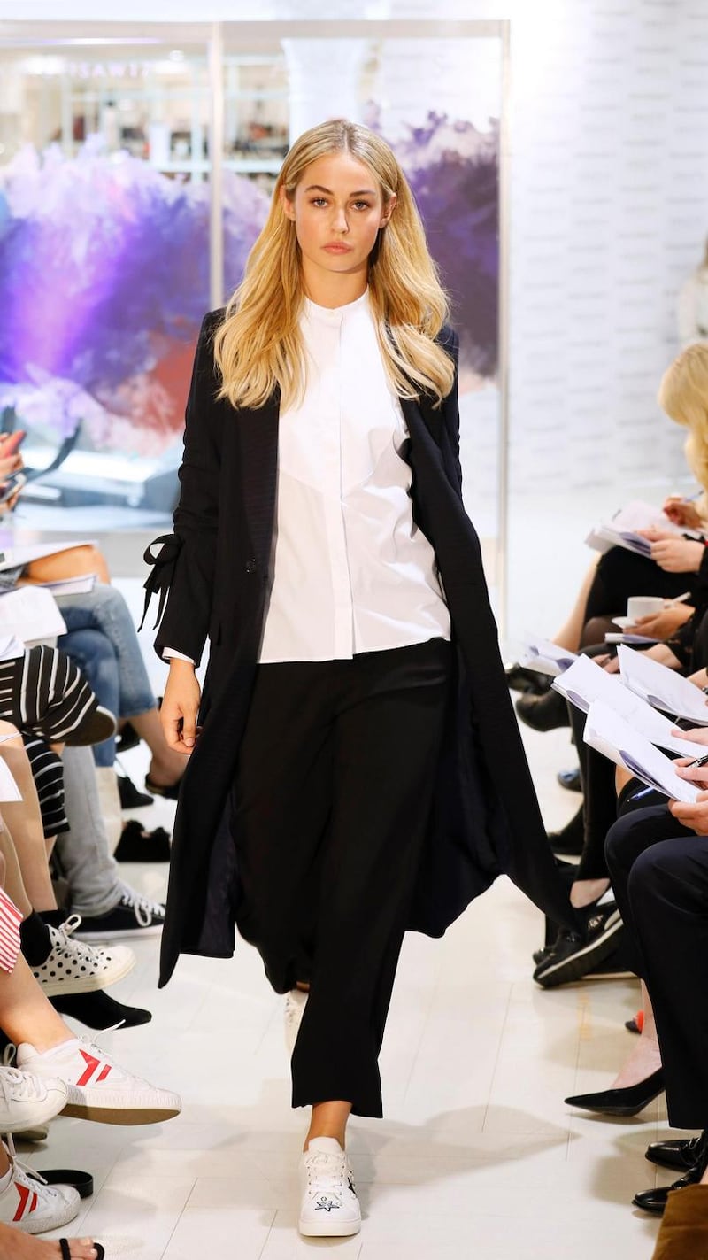 no fee if Arnotts mentioned in caption at the Arnotts Autumn Winter 2017 Womenswear Show-photo Kieran HarnettThalia Navy long pinstripe coat, HUGO Hugo Boss, €599White grandad collar shirt, Gant, €135Black cropped tailored trousers, Reiss, €210Trainers by Kurt Geiger
