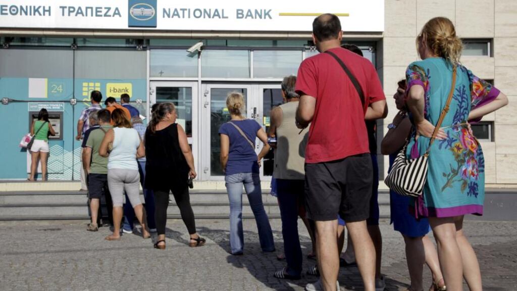 People line up to withdraw cash on the Greek island of Crete on Sunday. Photograph: Stefanos Rapanis/Reuters.
