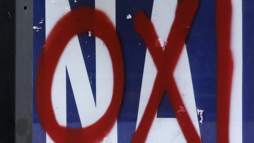 A referendum campaign poster that reads ‘Yes (Nai)’ is seen on a bus stop with a graffiti that reads ‘No (Oxi)’ painted on it in Athens, on Friday. Photograph: Reuters