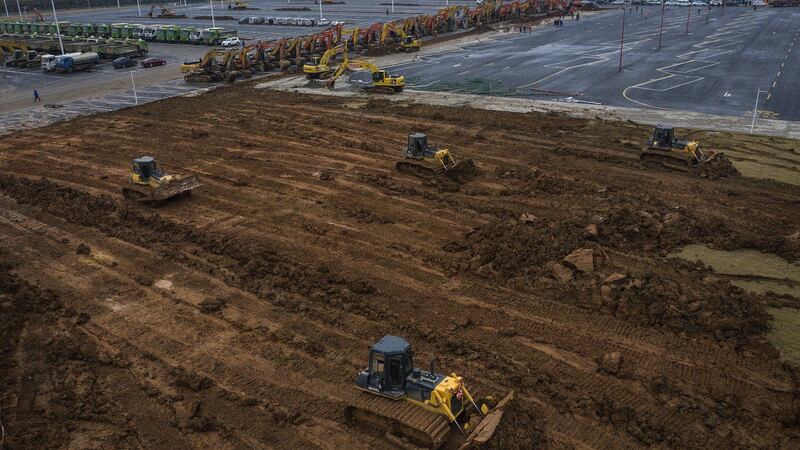 Bulldozers are used at a construction site of a field hospital in Wuhan, Hubei province, China. Wuhan Leishenshan hospital will be completed on February 5th, with a capacity of 1,300 beds for coronavirus patients, according to the government. Photograph: Getty
