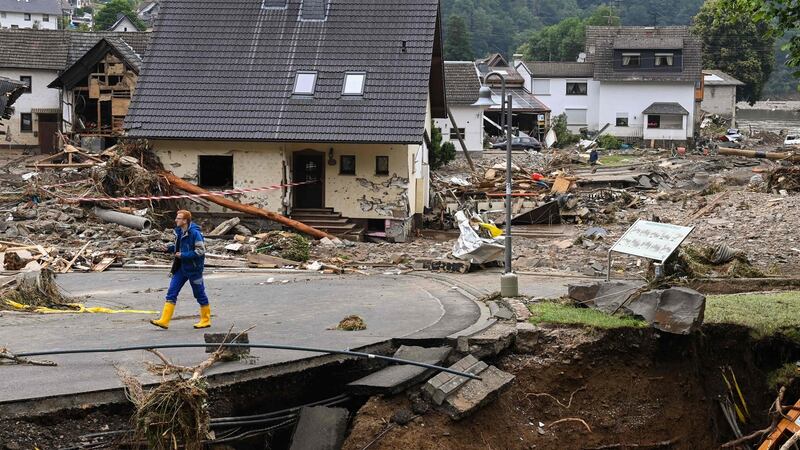 A man walks on a partially slipped road amid destroyed houses after the floods caused major damage in Schuld near Bad Neuenahr-Ahrweiler. Photograph: AFP via Getty Images