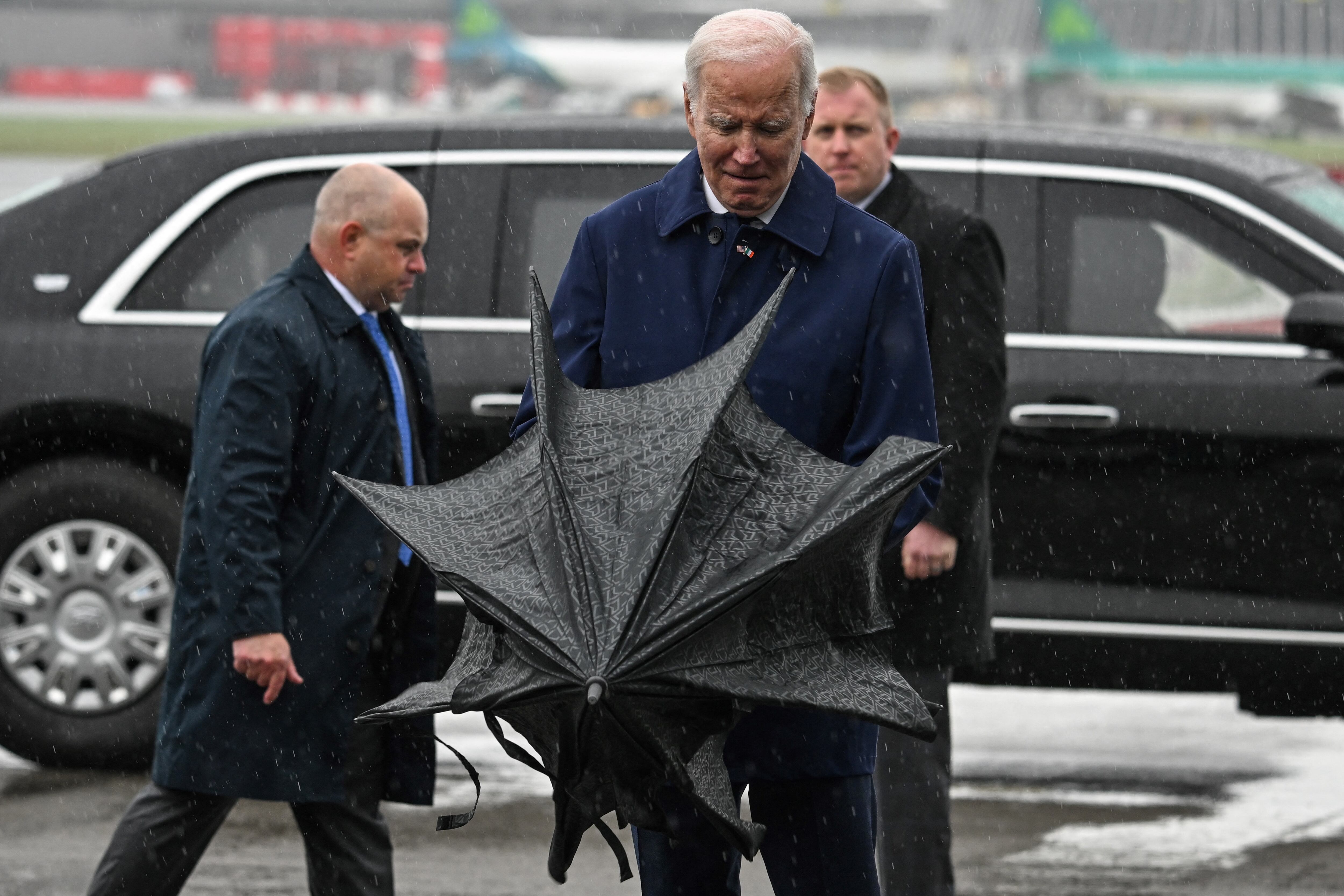 Biden opens an umbrella after landing into wet weather on Wednesday in Dublin. Photograph: Jim Watson/AFP via Getty