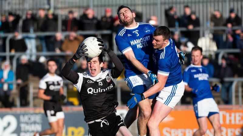 Kilcoo’s Eugene Branagan claims the ball as Naomh Conaill’s AJ Gallagher and Leo McLoone collide during the AIB Ulster Club SFC Final at Healy Park in Omagh. Photograph: Evan Logan/Inpho