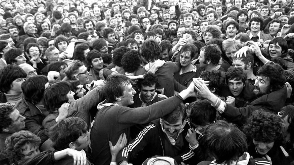 The Munster players are carried from the pitch in 1978.