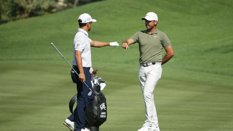 Jason Day bumps fists with Xander Schauffele as he withdraws from the CJ Cup. Photo: Jeff Gross/Getty Images