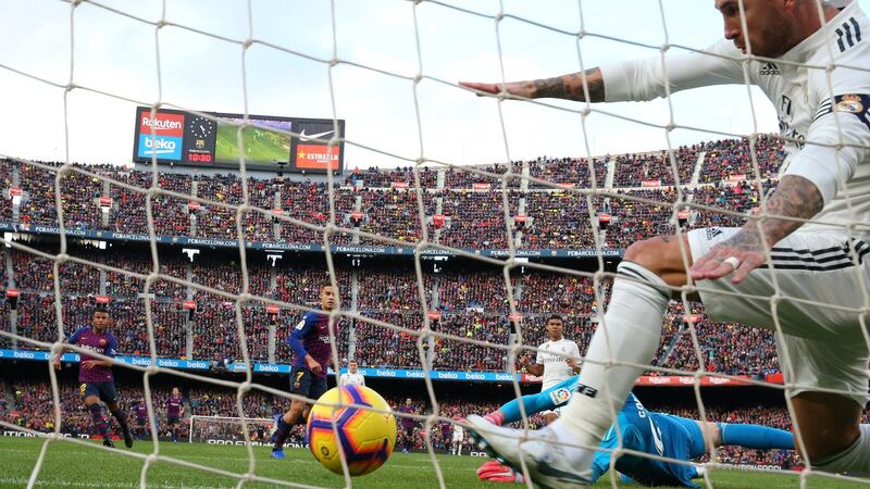 Philippe Coutinho scores Barcelona’s first against Real Madrid. Photograph: Albert Gea/Reuters