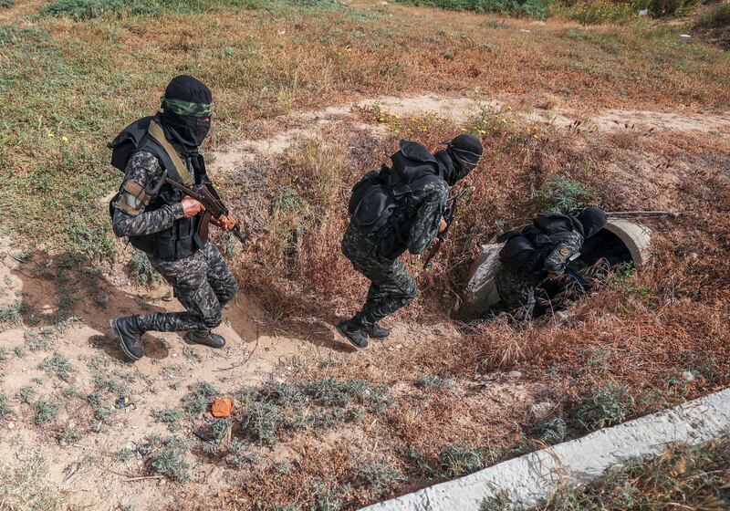 Members of the Palestinian Islamic Jihad militant group enter a tunnel in Gaza in April 2022, during a media tour. Photograph: Mahmud Hams/AFP via Getty Images