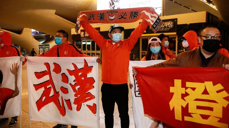 Some Wuhan Zall fans welcome the team back. Photo: AFP via Getty Images