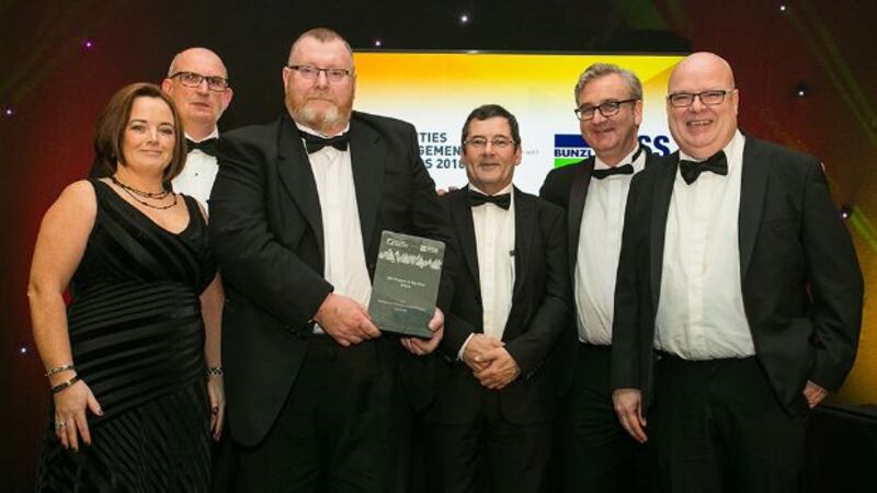 John Lawlor, Managing Director, Synergy Security Solutions presents the FM Project of the Year - Office award to DellEMC Team