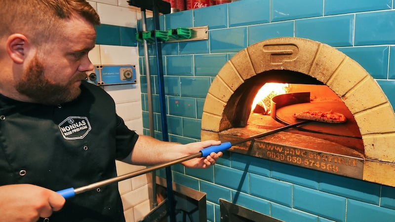 Kealon Quigg, a chef at Nonna’s Wood Fired Pizzas in Derry, working at the restaurant’s wood-fired oven. Photograph: Trevor McBride