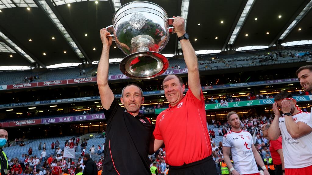 Tyrone joint managers Brian Dooher and Feargal Logan lift the Sam Maguire cup. Photo: Ryan Byrne/Inpho