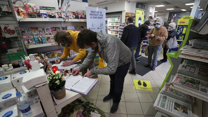 Local shop users queue to sign the books of condolence for Akram Hussain in the Centra Shop in Drumcondra, Dublin. Photograph: Nick Bradshaw/The Irish Times
