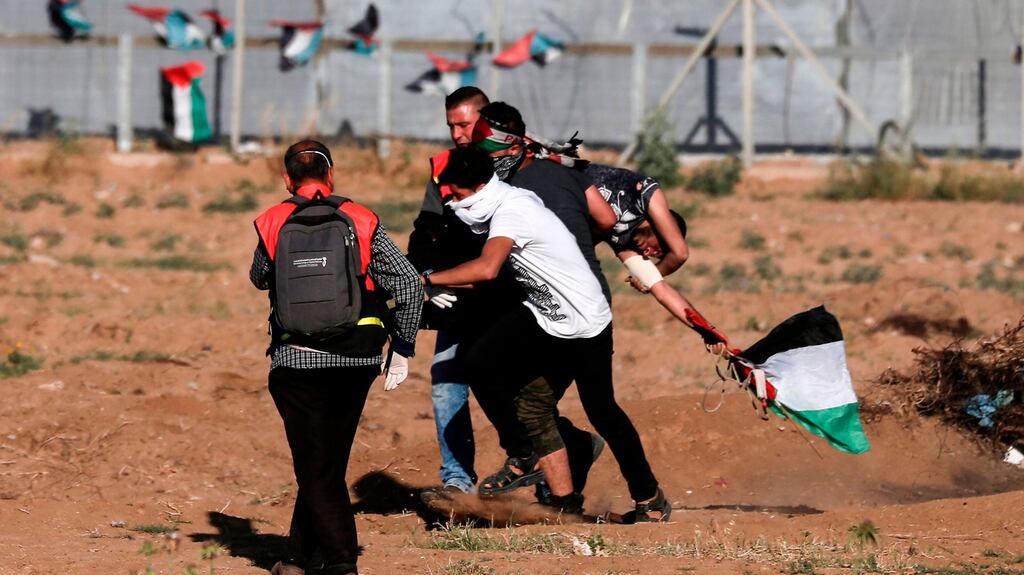 Palestinian paramedics carry an injured protester during clashes with Israeli forces following a demonstration by the border fence with Israel, east of Gaza City, on May 3rd, 2019. Photograph: Mahmud Hams/AFP/Getty Images
