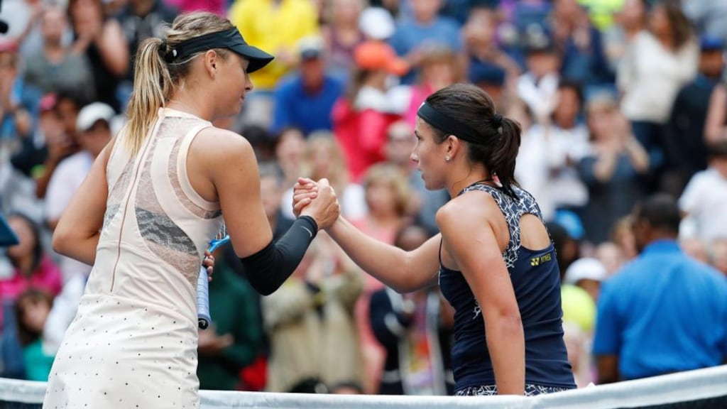 Maria Sharapova  congratulates Anastasija Sevastova after she was knocked out of the US Open by the 16th seed. Photograph: John G. Mabanglo/EPA