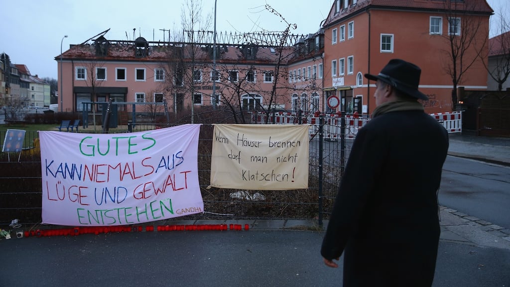 Banners left by people opposed to the attack next to the burnt-out remains of a former hotel that was to serve as a shelter for 300 refugees following a fire early on Sunday morning in Bautzen, Germany. Photograph: Sean Gallup/Getty Images.
