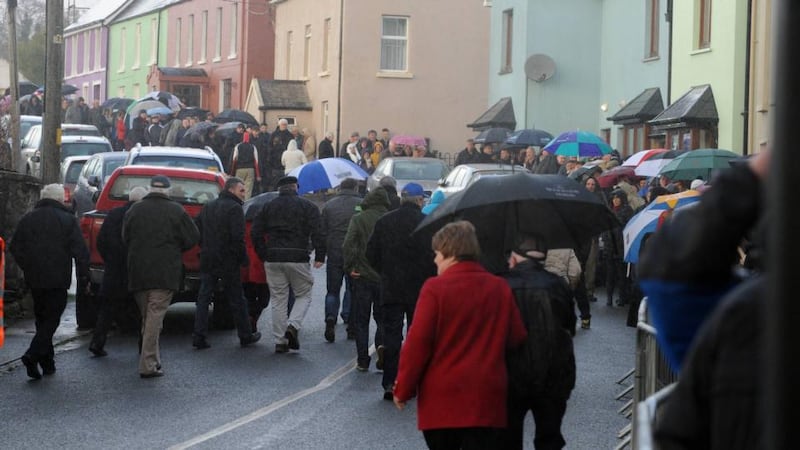 Mourners arrive in the rain to pay their respects to the late Jackie Healy-Rae in Kilgarvan, Co Kerry, on Sunday. Photograph: Don MacMonagle