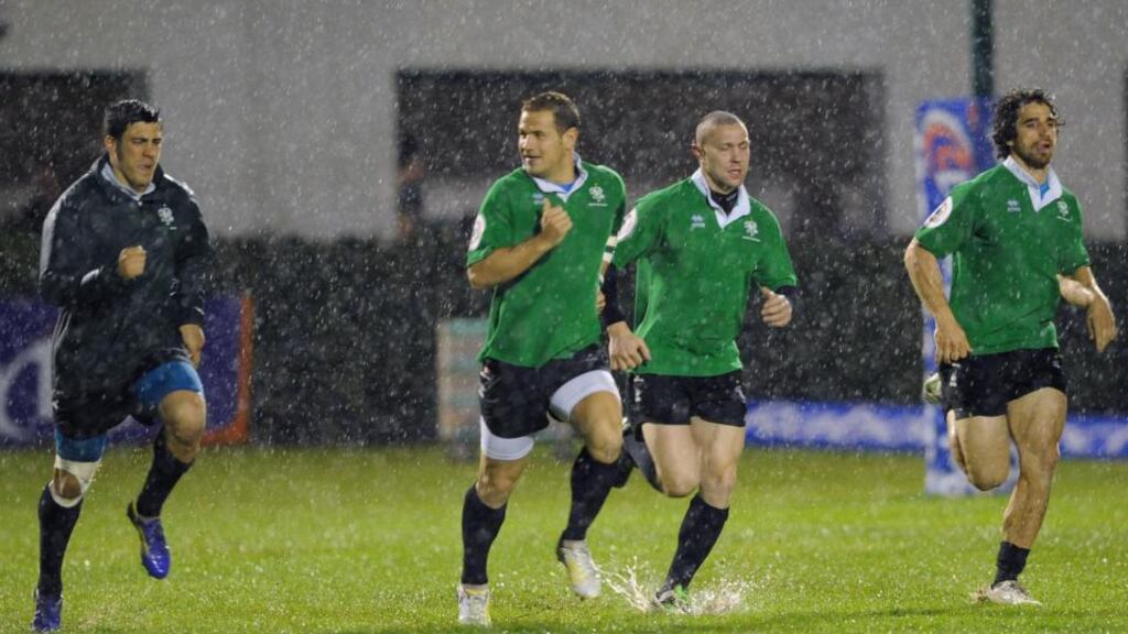 Players attempt to run on the pitch before the match was called off in Treviso last night. Photograph: Elena Barbini/Inpho