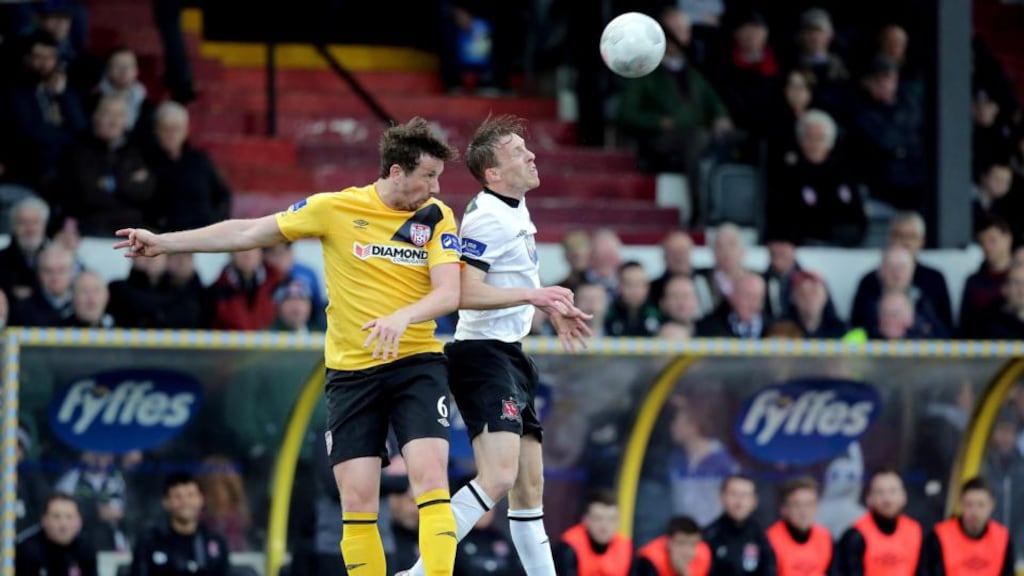 Shane McEleney of Derry City challenges for the ball with David McMillan of Dundalk during the SSE Airtricity League Premier Division match at Oriel Park. Photo: Morgan Treacy/Inpho