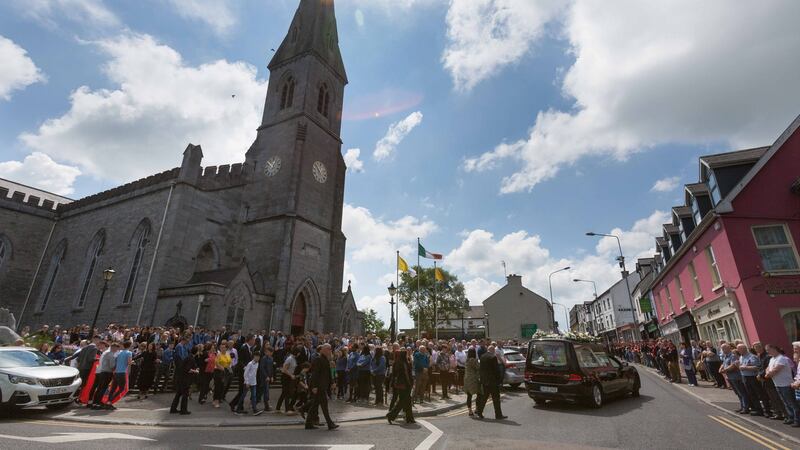 Mourners follow the hearse as it leaves the Cathedral on Monday morning. Photograph: Eamon Ward