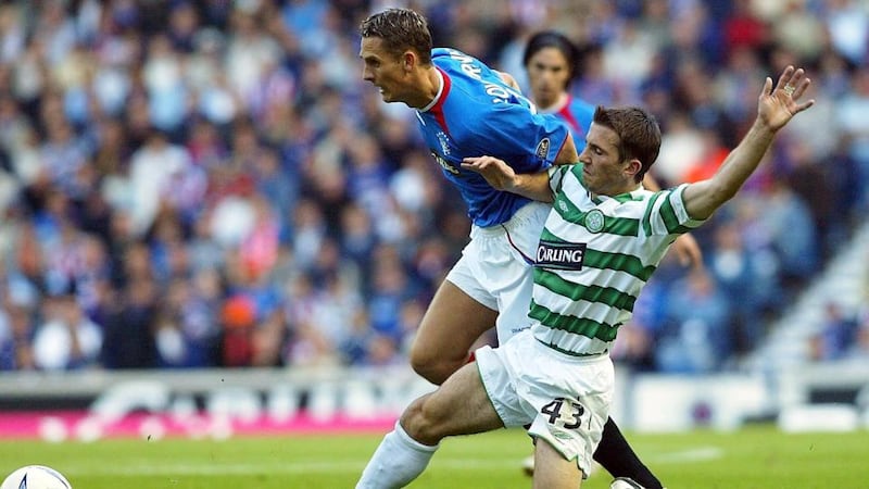 Liam Miller tackles Peter Lovenkrands durinf an Old Firm derby in 2003. Photograph: Inpho
