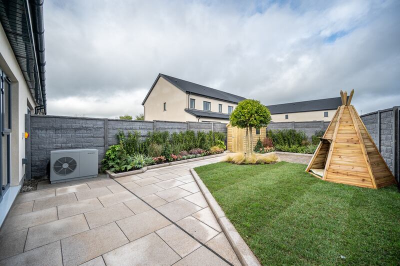 Double doors lead out to the rear garden, flanked by long windows.
