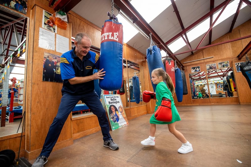 YOU GO GIRL: Paddy Corcoran, club chairman and coach, with Penny Moore (6), training at Kellie Harrington's first boxing club, Corinthians, on Bella Street, Buckingham Street Upper, Dublin. He has called for funding for upgraded facilities for girls in the wake of Harrington's gold medal win in Tokyo. Photograph: Tom Honan