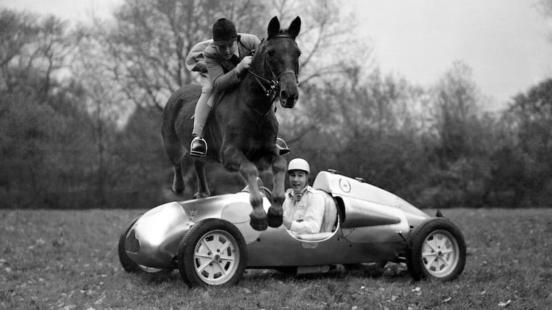Stirling Moss’s 14-year-old sister Pat jumps over his car on her pony in 1949. Photo: PA/PA Wire