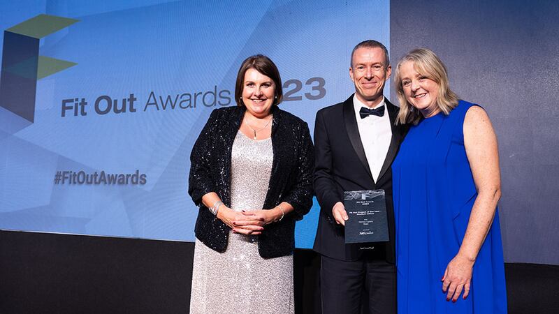 JP Rust, managing director at SIG Workplace, presents the fit out project of the year – medium office award to Mary Banks and Sarah Dixon, Henry J Lyons