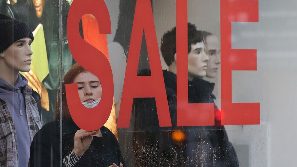 St Stephen’s Day sales in Dublin city centre. A store worker puts the finishing touches to signage this morning ahead of opening. Photograph: Nick Bradshaw/The Irish Times