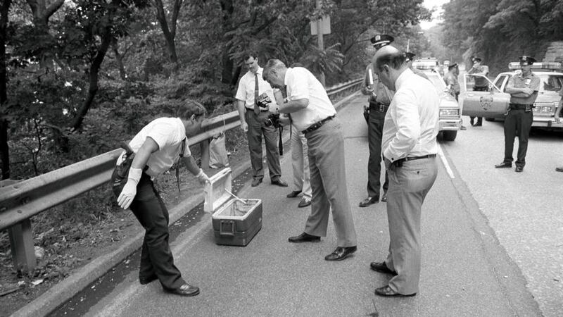 Police officers examine a picnic cooler with the corpse of a small child in it found on the southbound side of the Henry Hudson Parkway in New York, July 23, 1991. Photograph: James Estrin/The New York Times
