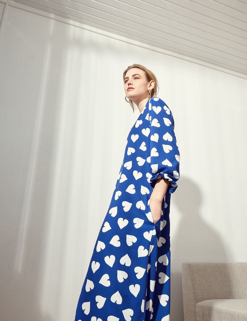 Blue heart print dress €249 Essential Antwerp, shoes €115 Kurt Geiger, earrings €89 Calvin Klein, West Elm Andes corner sofa €269