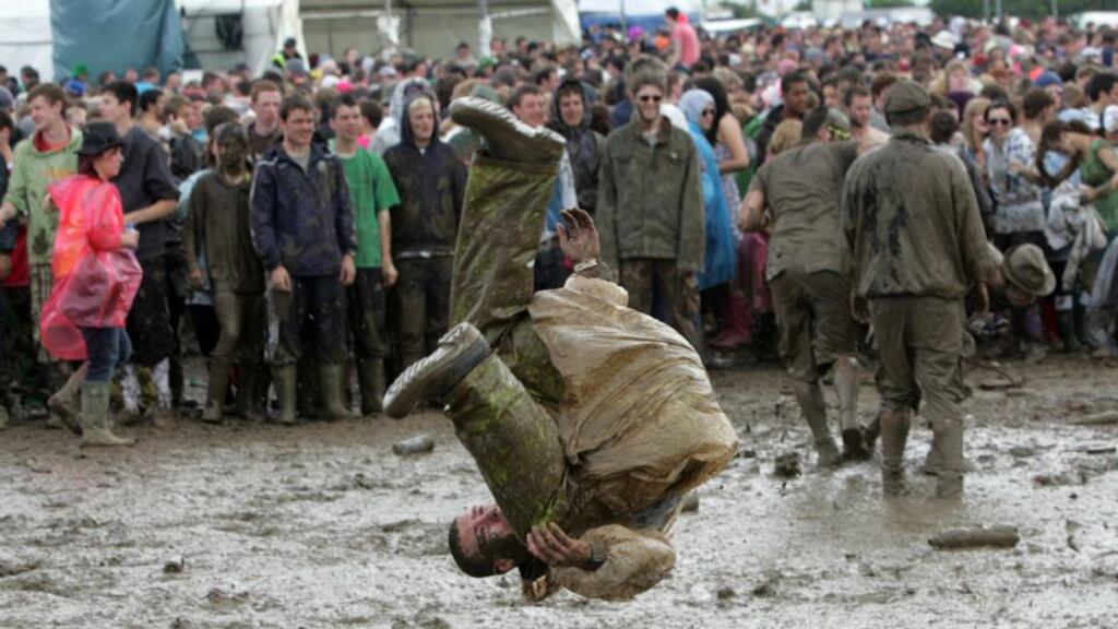 Festival goers enjoying a mud bath at Oxegen music festival. Photograph: Alan Betson