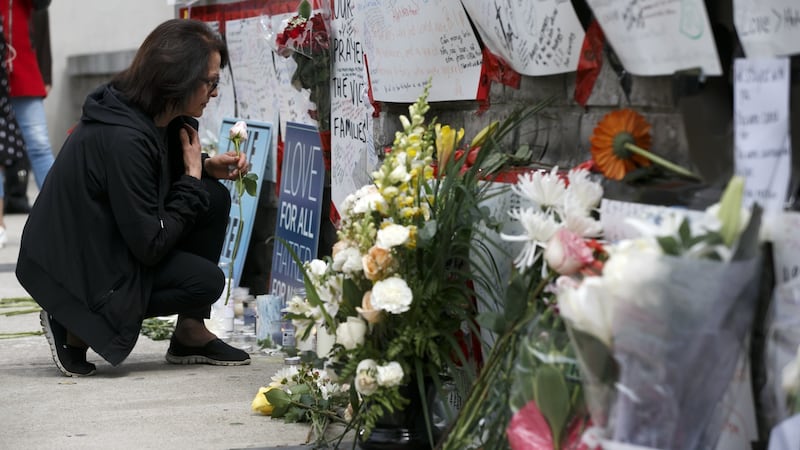 A woman leaves a flower at a memorial for victims of the mass killing on Yonge Street at Finche Avenue on April 24th, 2018, in Toronto. Alek Minassian is the suspect. Photograph: Cole Burston/Getty Images