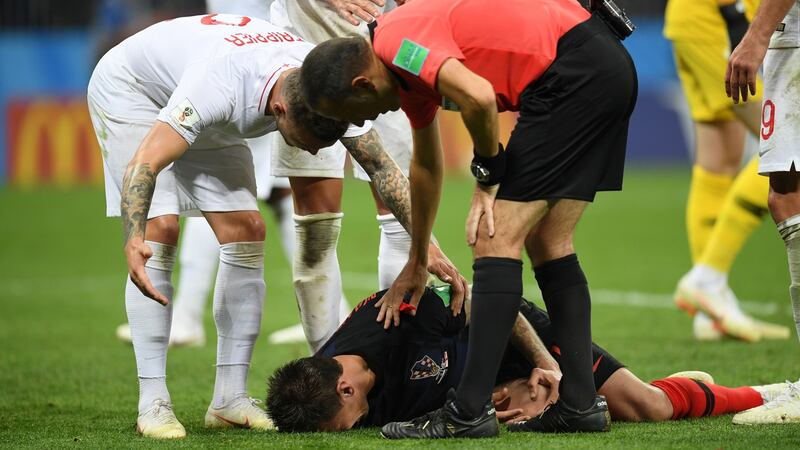 Referee Cuneyt Cakir checks on Mario Mandzukic of Croatia after he goes down after colliding with Jordan Pickford’s studs. Photograph: Matthias Hangst/Getty Images