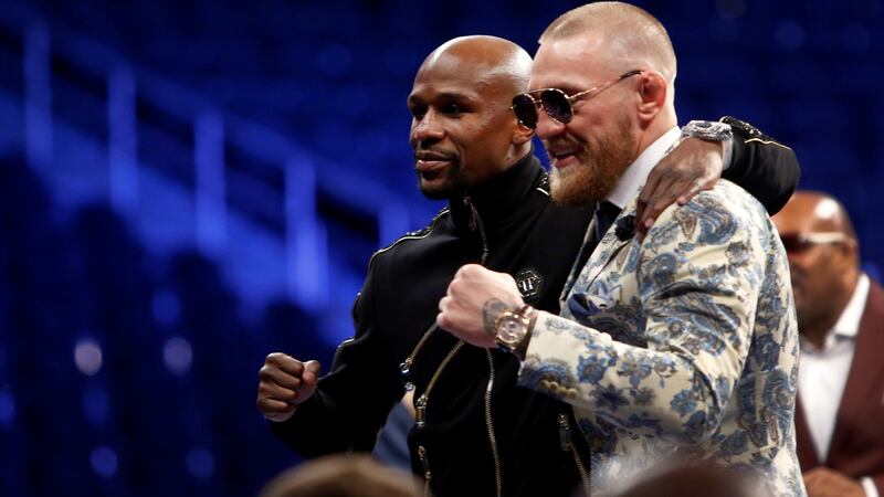 Mayweather and McGregor pose together at the post-fight press conference. Photo: Steve Marcus/Reuters