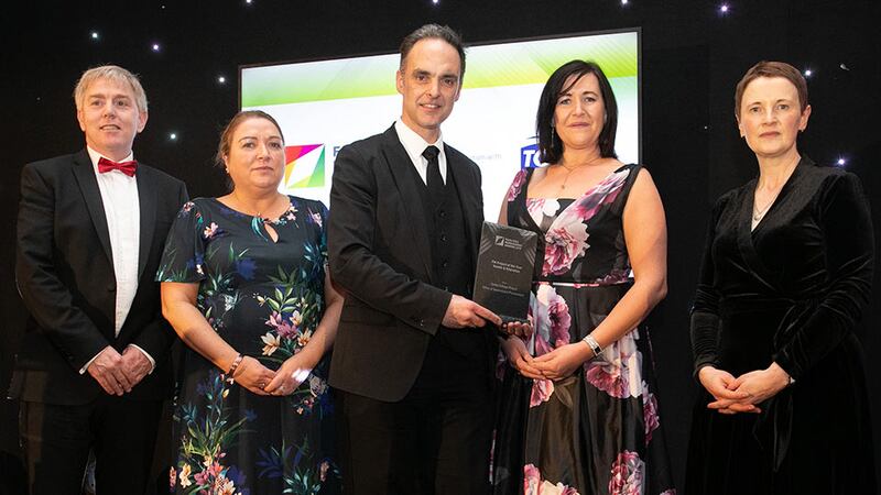 Paul Guy, Head of Marketing and Communications, Aramark Workplace Solutions presents the FM Project of the Year - Health & Education award to the Office of Government Procurement & Garda College Templemore Team.