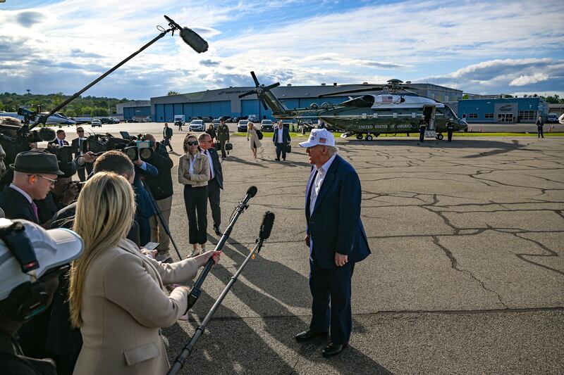 President Donald Trump speaks to reporters at Morristown Municipal Airport. Photograph: Kenny Holston/The New York Times