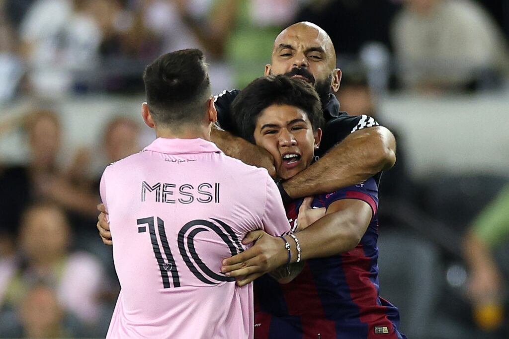 Yassine Cheuko intervenes to restrain a fan who had entered the pitch to run towards Lionel Messi during inter Miami's game against Los Angeles FC at BMO Stadium in Los Angeles, California. Photograph: Harry How/Getty Images