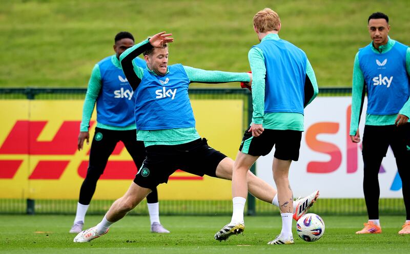 Ireland's Nathan Collins stretches for the ball in training as Adam Idah (right) looks on. Photograph: Ryan Byrne/Inpho