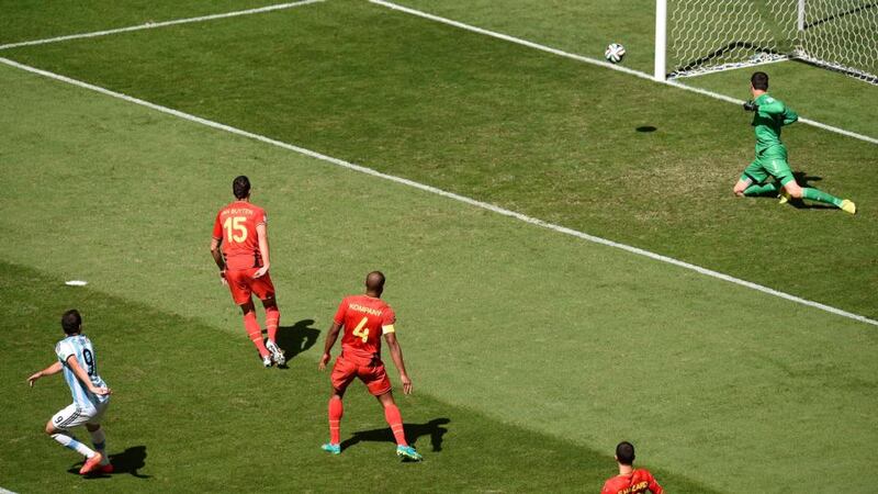Gonzalo Higuain (left) of Argentina scores past Belgian goalkeeper Thibaut Courtois at the Estadio Nacional in Brasilia. Photograph: Shawn Thew / EPA