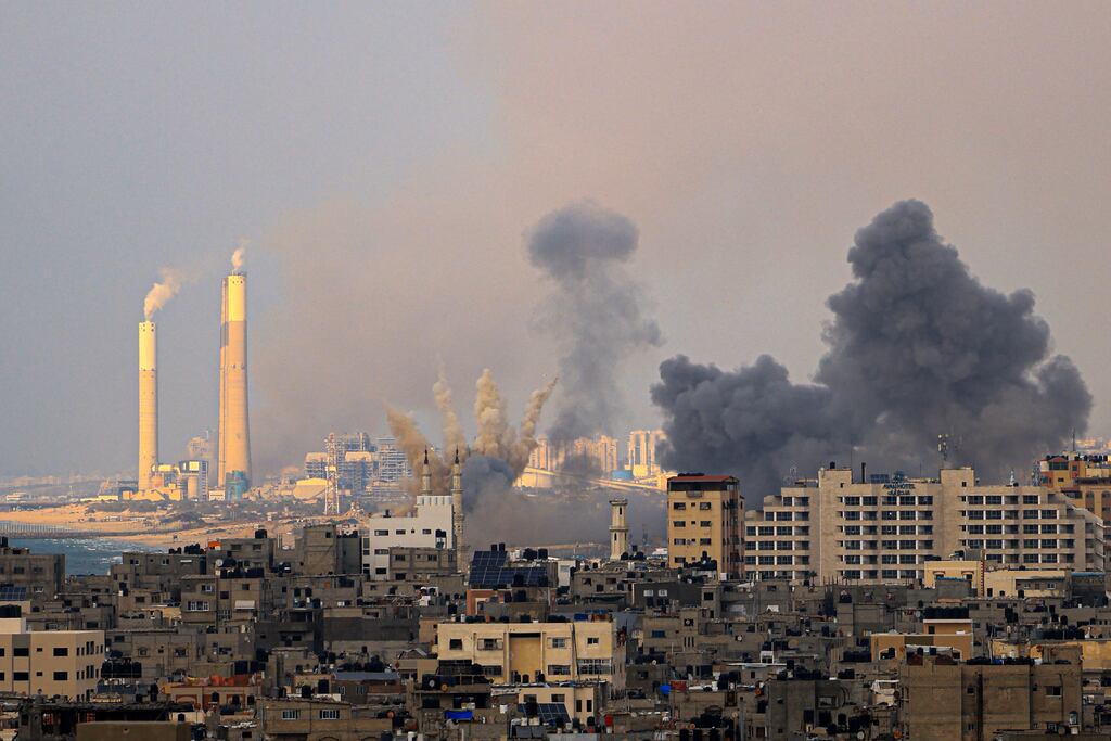 Smoke billows behind high-rise buildings in Gaza during Israeli air strikes on Monday. Photograph: Mahmud Hams/AFP via Getty