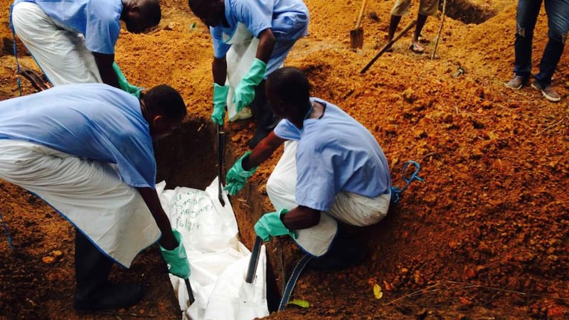 Threat: in Sierra Leone and other African countries, victims are being buried. Photograph: Tarik Jasarevic/WHO/Reuters