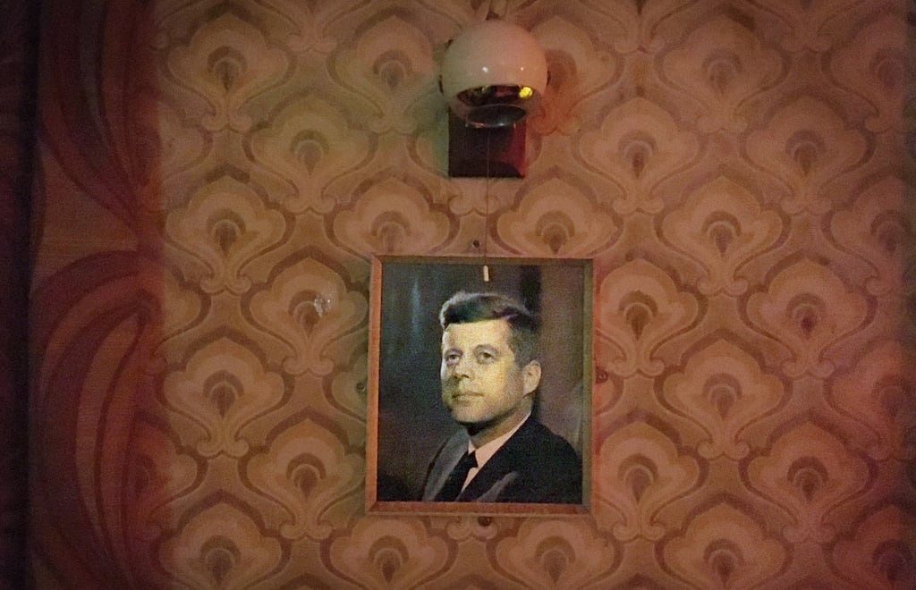 'There was nowhere to deposit the float from his pub at the end of the day, so my father took to carrying the money home – with a gun.' File photograph of a portrait of JFK on the wall of a pub: Bryan O'Brien