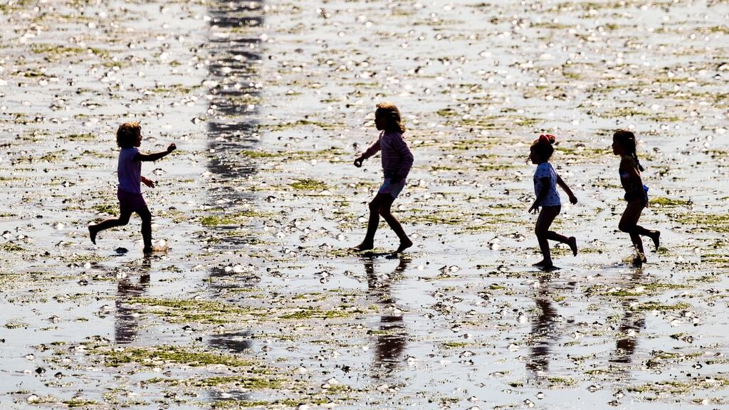 Children  playing the in low tide on Dollymount Strand. Photograph: Tom Honan/The Irish Times.