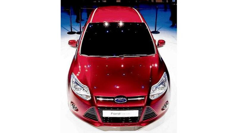 Main picture: Ford's Raptor 6.2-litre petrol pick-up; left: the new European-styled Ford Focus at its launch in Detroit; below: Ford's Fusion Hybrid range