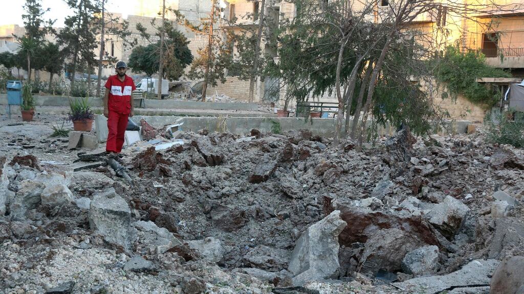 A Syrian medical staff member inspects the damage at the site of a medical facility after it was reportedly hit by Syrian regime barrel bombs on October 1st in the rebel-held neighbourhood of al-Sakhour, in the northern city of Aleppo. Photograph: Thaer Mohammed/AFP/Getty Images